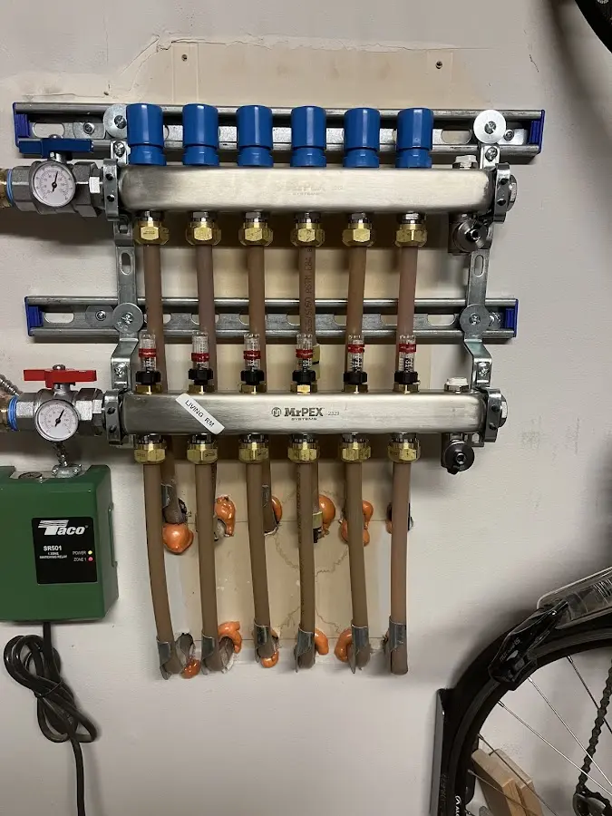 Plumber performing Water Heater Repair at a residential property in Merrill